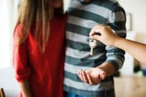 person handing over house keys