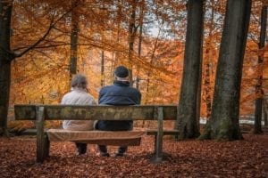 elderly couple sitting on bench