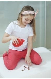 girl counting piggy bank coins