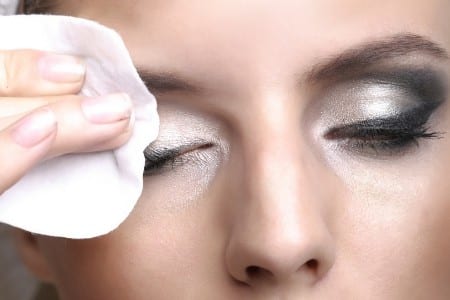 woman removing eye makeup