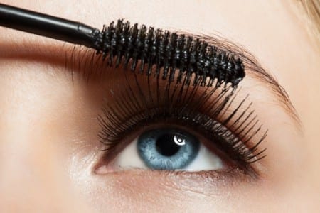 Woman's eye and mascara brush