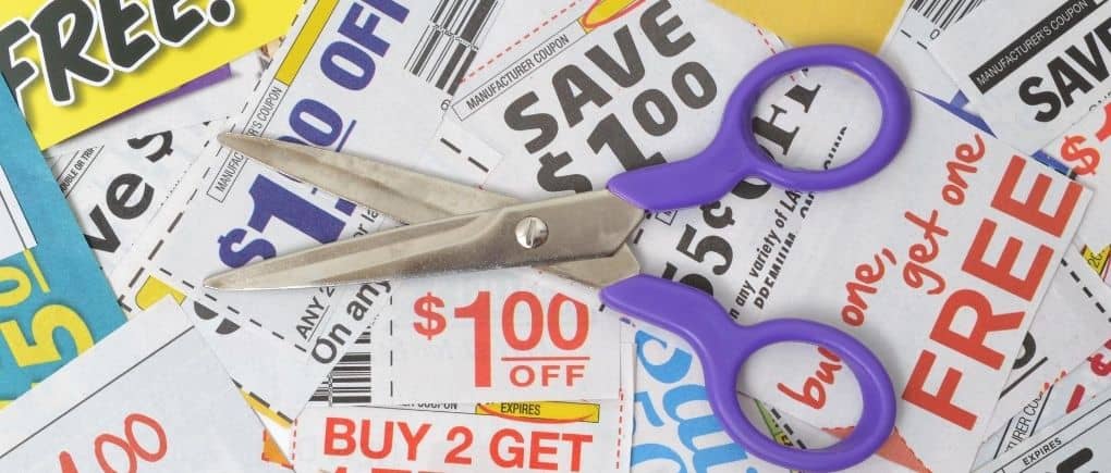 Pair of scissors on top of clipped coupons