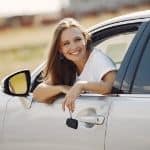 Smiling woman leaning out of car window