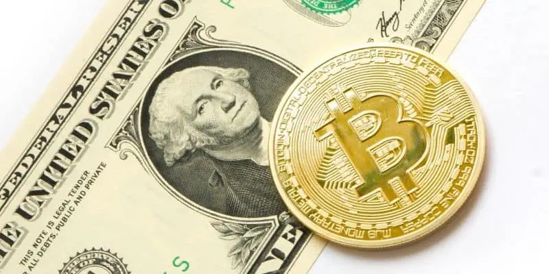 dollar bill with bitcoin 'coin' on top