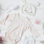 baby clothes, bottle, booties and soft toy rabbit