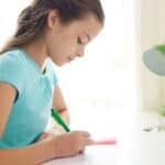 Young girl writing at desk