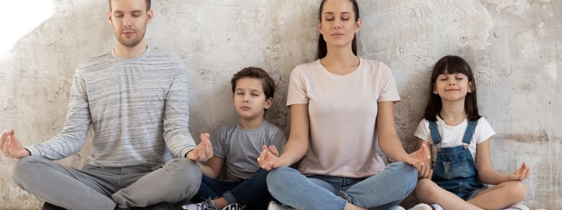 family meditating together